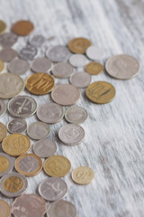 Different collector coins on the wooden background, soft focus background
