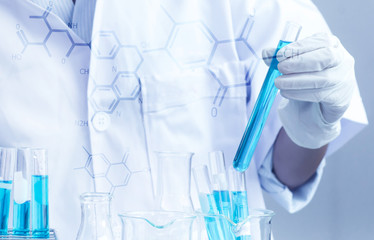 Asian women scientist with test tube making research in clinical laboratory.Science, chemistry, technology, biology and people concept