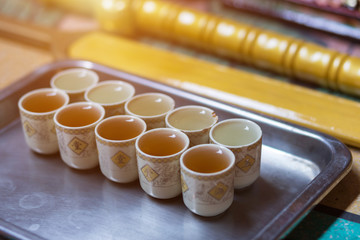 Cups Of Chinese tea in a row To worship deity at Chinese shrine.