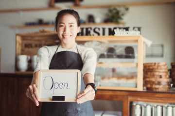 Portrait Asian woman business owner with bakery shop background