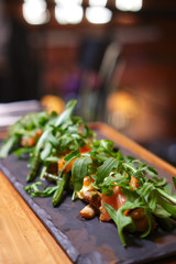 Smoked salmon with mushroom and bean decorated with ruccola