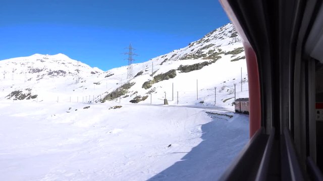 Red train on Bernina Pass in Winter season