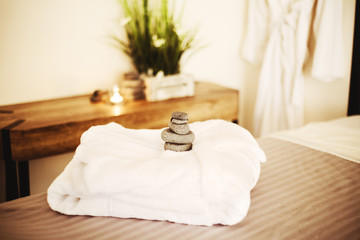 White bathrobe on the bed in the spa salon