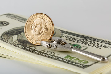 Dollar coin on a pack of banknotes