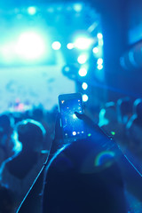 Kyiv. Ukraine. August 2015. A fan shoots a music concert in the backlight