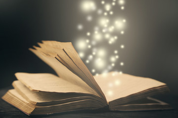 old book open light  effect moving up particles photo