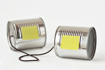 Tin cans phone with paper note - Communication concept