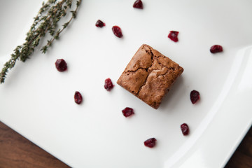  Beautiful serving, decorating chocolate dessert, brownie. Garnished with berries and greens.