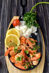 Roasted shrimps with lemon, garlic,herbs and white rise, seafood shelfish shrimps prawns grilled with spices