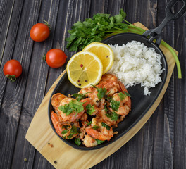 Roasted shrimps with lemon, garlic,herbs and white rise, seafood shelfish shrimps prawns grilled with spices