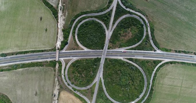 4K aerial footage&nbsp;of highway intersection. Road junction with traffic. Top view

