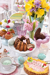  festive table decoration with traditional easter pastries and confectionery - obrazy, fototapety, plakaty