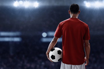 Obraz premium Soccer player holding soccer ball