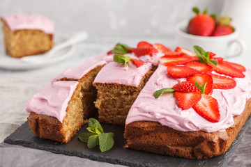 Yogurt pound cake for breakfast with pink glaze and fresh strawberries. Light background, summer dessert. Breakfast concept.