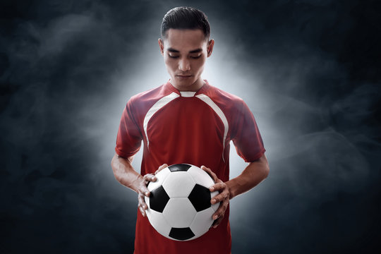 Soccer Player Holding Soccer Ball