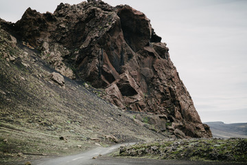 empty rural road and scenic cliff in Landmannalaugar, iceland