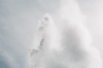 water from powerful geyser and cloudy sky, Geysir, iceland