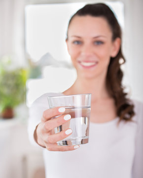 Woman offering glass of water
