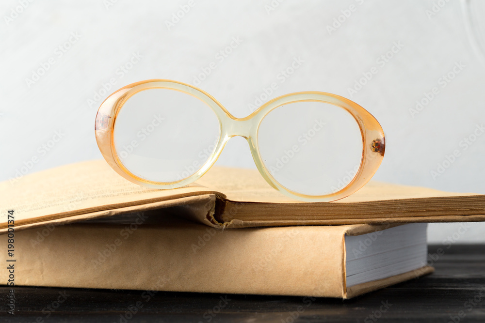 Wall mural eyeglasses and book on the table