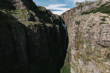 majestic Glymur waterfall between rocks in iceland