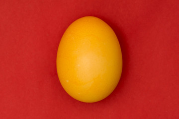 Yellow Easter egg on red background