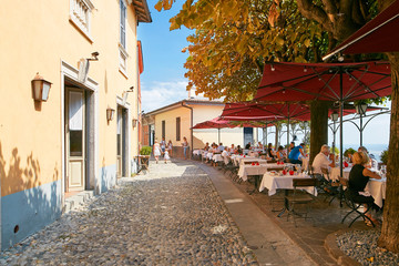 Fototapeta na wymiar Bergamo, Italy - August 18, 2017: Cozy street cafe in the upper city.