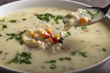 Close up of spoon with Romanian traditional soup - Ciorba de Burta