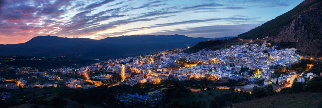 Panorama night city of Chefchaouen Morocco. Blue city in night lights. Journey through Morocco, magical place. Sunset over Chefchaouen, Morocco. Panoramic view of the city