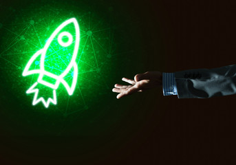 Man palm presenting Rocket web icon as technology concept
