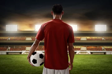 Gordijnen Soccer player holding soccer ball © fotokitas