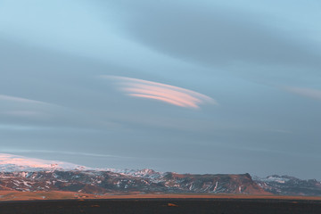 beautiful snow-covered rocky mountains and cloudy sky in iceland