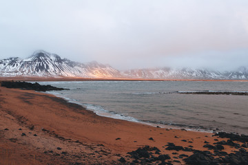 spectacular view of snow-covered mountains, fjord and rainbow in iceland