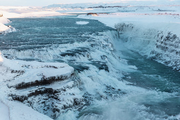 magnificent icelandic landscape with Gullfoss waterfall and snow-covered rocks