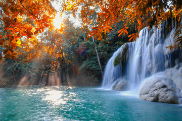 Scenic of nature Beautiful Waterfall with sunlight in autumn forest at Erawan  National Park,...