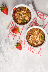 Homemade breakfast strawberry crumble. Mini berry cake with strawberry, light background, top view, copy space. Healthy vegan food concept.