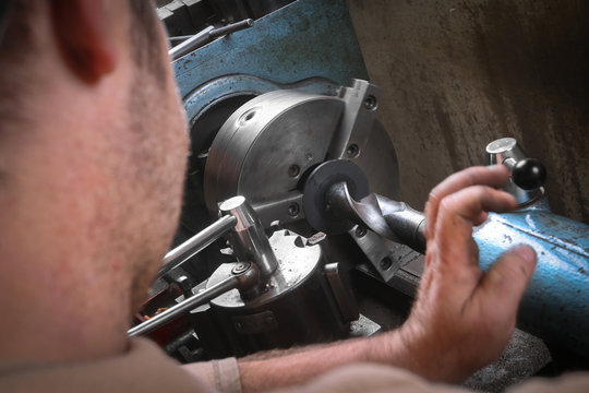 Metal worker working on lathe machine