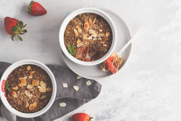 Homemade breakfast strawberry crumble. Mini berry cake with strawberry, light background, top view, copy space. Healthy vegan food concept.