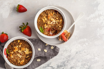Homemade breakfast strawberry crumble. Mini berry cake with strawberry, light background, top view, copy space. Healthy vegan food concept.