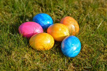 Several colorful Easter eggs lying on grass