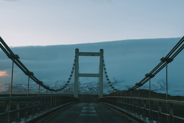 driving on bridge at cold sunset in iceland