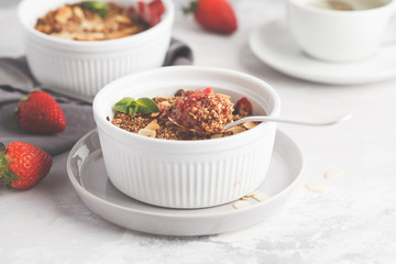Homemade summer breakfast strawberry crumble. Mini berry cake with strawberry, light background. Healthy vegan food concept.