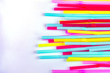 blue, pink and yellow straws for cocktails and other drinks isolated on white background