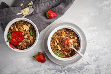 Homemade breakfast strawberry crumble. Mini berry cake with strawberry, gray background, copy space, top view. Healthy vegan food concept.