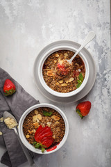 Homemade breakfast strawberry crumble. Mini berry cake with strawberry, gray background, copy space, top view. Healthy vegan food concept.