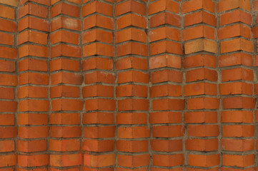 The texture of a brick wall with curly brickwork