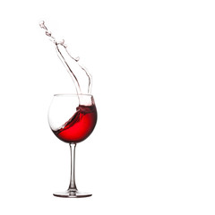 Red wine splashing. Pouring wine into crystal glass, close-up, white background. copy space.