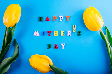 Happy Mother's day. Mother's Day concept. Lettering with yellow tulips