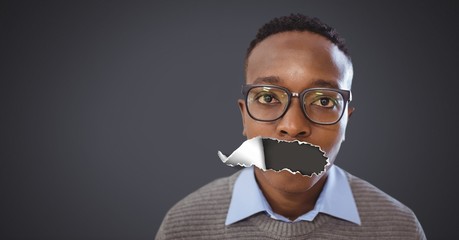 Young man with torn paper on mouth