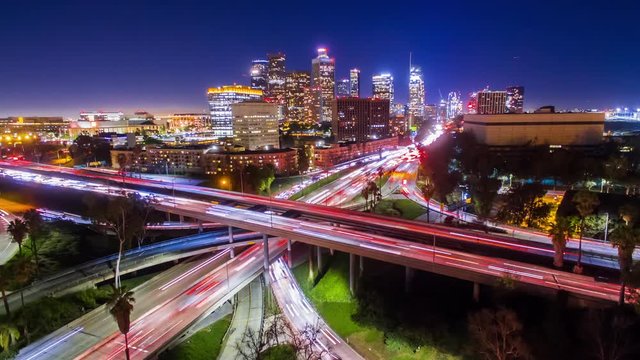 4K Static Aerolapse ( timelapse / hyperlapse ) view of huge traffic on freeway interchange of 110 and 101 freeways in downtown Los Angeles skyline at night.