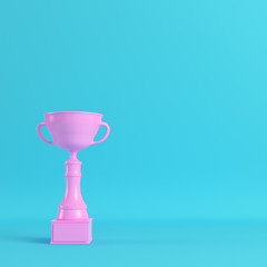 Pink trophy cup on bright blue background in pastel colors